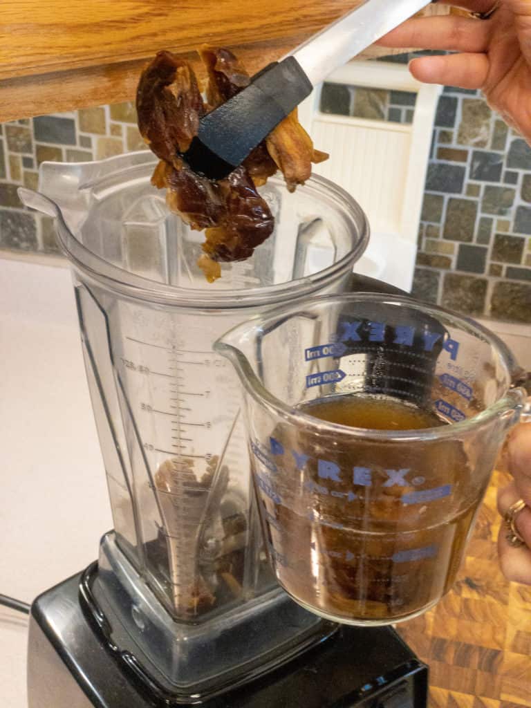 Medjool dates being placed into a blender