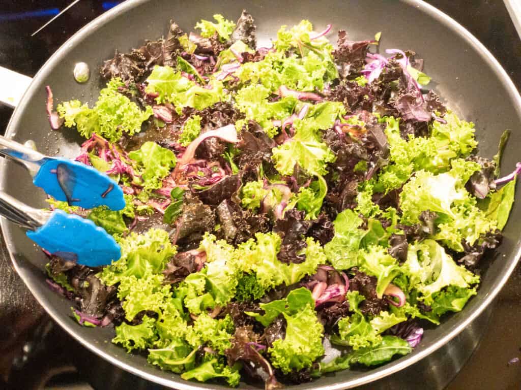 Sweet Maple Pecan Greens in pan with tongs